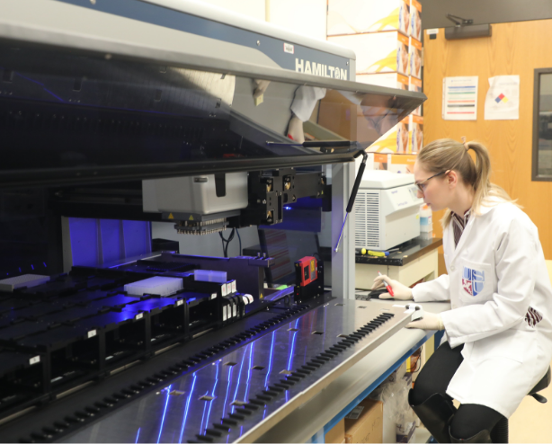 Woman in lab uses robot to study COVID-19 for research