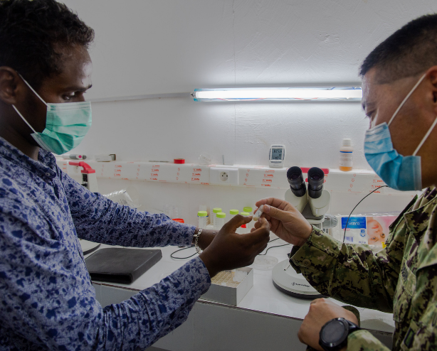 Microbiologist from Navy Medical Research Unit #3 inspects a sample at The National Institute of Public Health of Djibouti