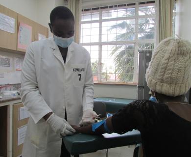 Clinician prepares to administer vaccine