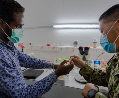 Microbiologist from Navy Medical Research Unit #3 inspects a sample at The National Institute of Public Health of Djibouti