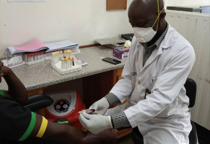 Clinician prepares to draw blood