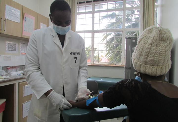 Clinician prepares to administer vaccine