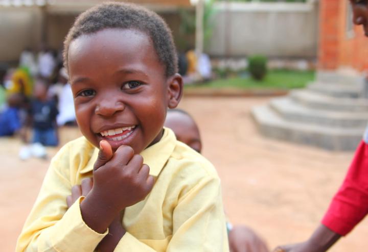 A child smiling outdoors