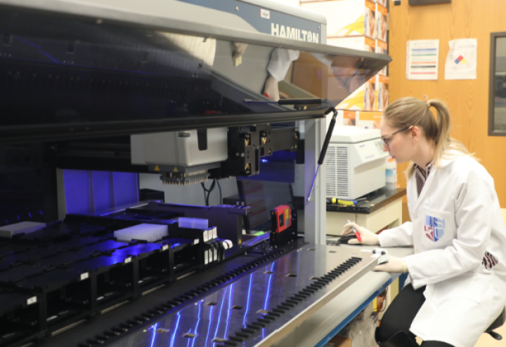 Woman in lab uses robot to study COVID-19 for research