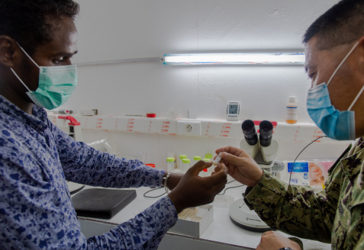 Microbiologist from Navy Medical Research Unit #3 inspects a sample at The National Institute of Public Health of Djibouti