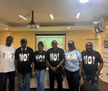 A group of trainers wearing t-shirts reading NO!