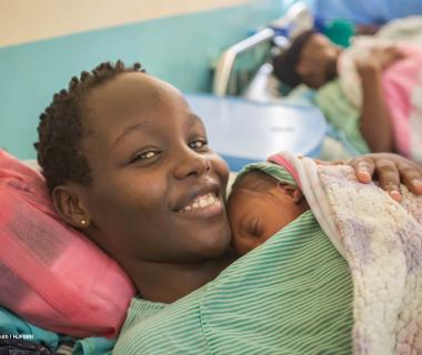 Mother holds her newborn skin-to-skin