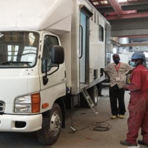 Project team supervising progress of the “Mobile Mortuary” 