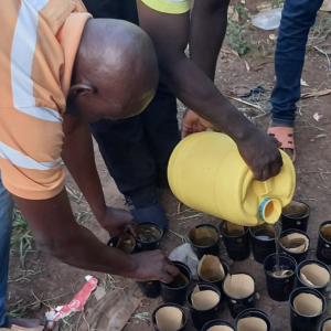 Two men fill cups with water