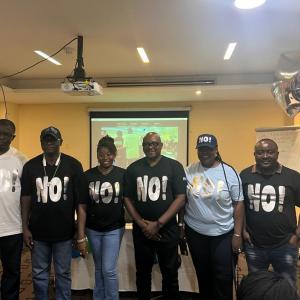 A group of trainers wearing t-shirts reading NO!