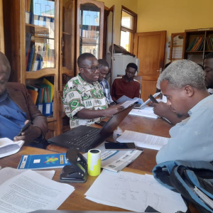 Men sitting around a table with training documents